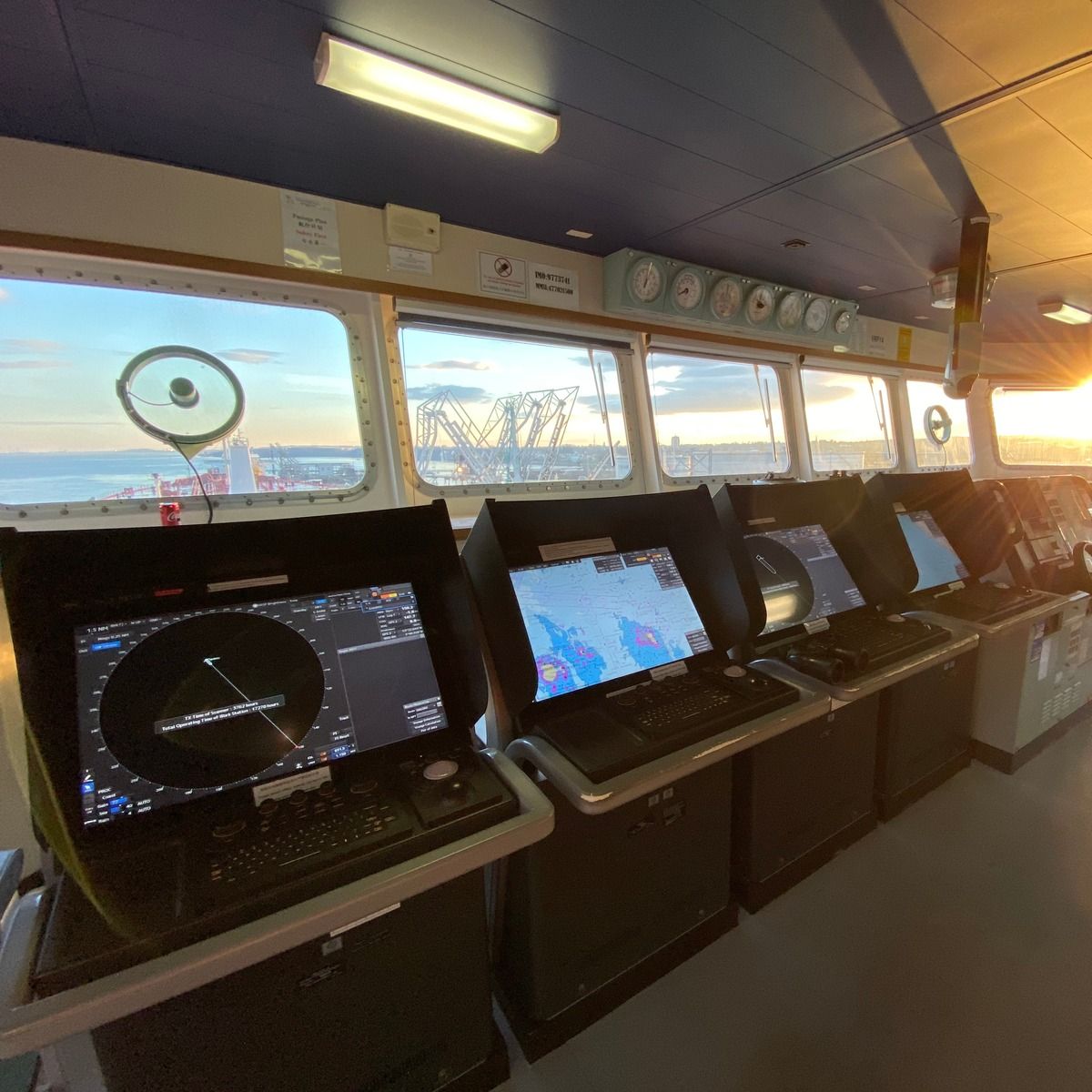 The bridge of a ship, consoles and radar displays facing the sea