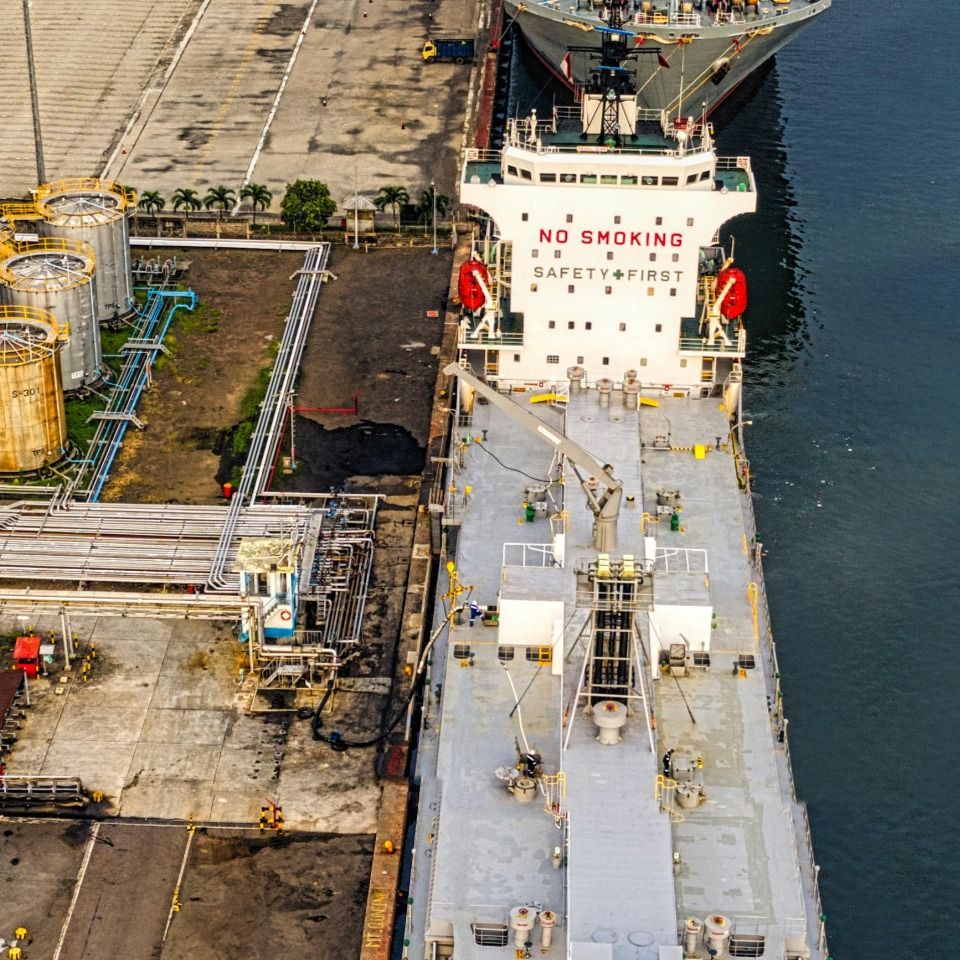 Aerial view of a tanker berthed at a port terminal